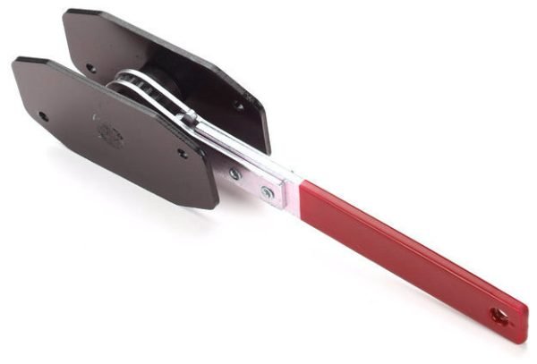 Angled view of the red-handled compact ratcheting brake spreader showing the black contact plates.