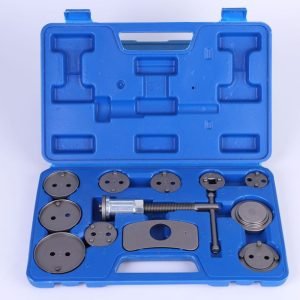 Open blue blow-molded case displaying the complete 12-piece brake caliper wind-back tool set, showing the main tool and various adapter plates.