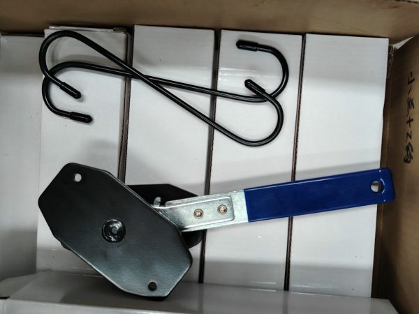 Angled view of the blue-handled compact ratcheting brake spreader showing the black contact plates.