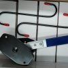 Angled view of the blue-handled compact ratcheting brake spreader showing the black contact plates.