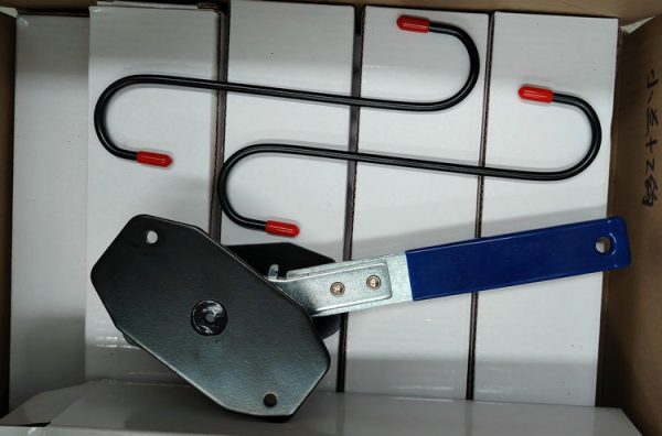 Angled view of the blue-handled compact ratcheting brake spreader showing the black contact plates.
