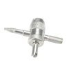 Silver 4-in-1 knurled valve core tool with a pointed threaded tip and six red rubber tire valve cores laid out below, used for car, truck, motorcycle and bike tires.