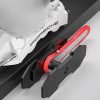 Full view of the red and black ratcheting brake caliper spreader with its two magnetic plates.