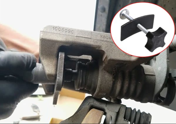 Full view of the black and silver brake caliper press tool showing the cross-handle and curved pressure plate.