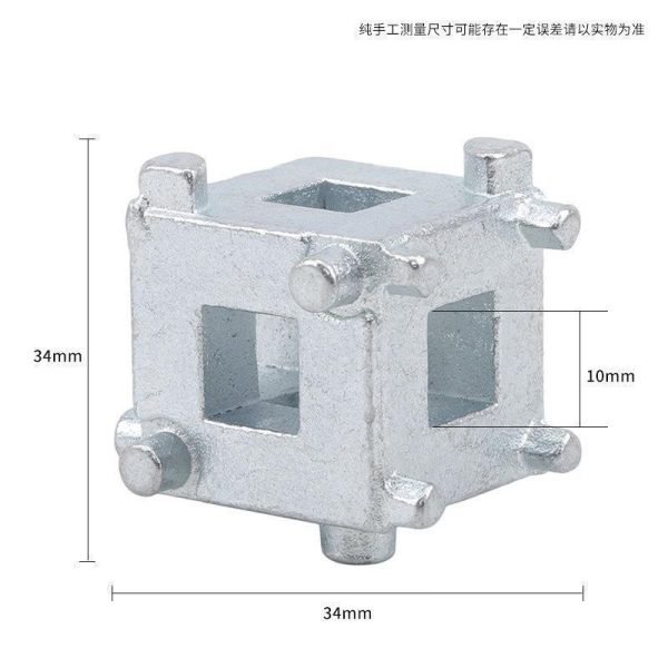 Close-up of the silver 34mm multi-functional brake wind-back adapter cube held in a hand to show scale.