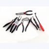 9-piece red and black automotive repair tool set featuring long nose pliers, hose clamp pliers, cutters, and a black anti-slip mechanic glove arranged on a white background.