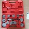 Open bright red blow-molded case displaying the complete 13-piece silver chrome brake caliper wind-back tool set.