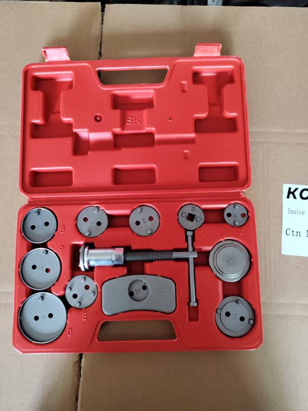Open bright red blow-molded case displaying the complete 13-piece silver chrome brake caliper wind-back tool set.