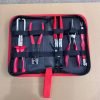 An overhead view of the 11-piece deluxe auto repair kit featuring pure red handle pliers, nylon trim removal tools, and electrical terminal extractors in a zippered case.