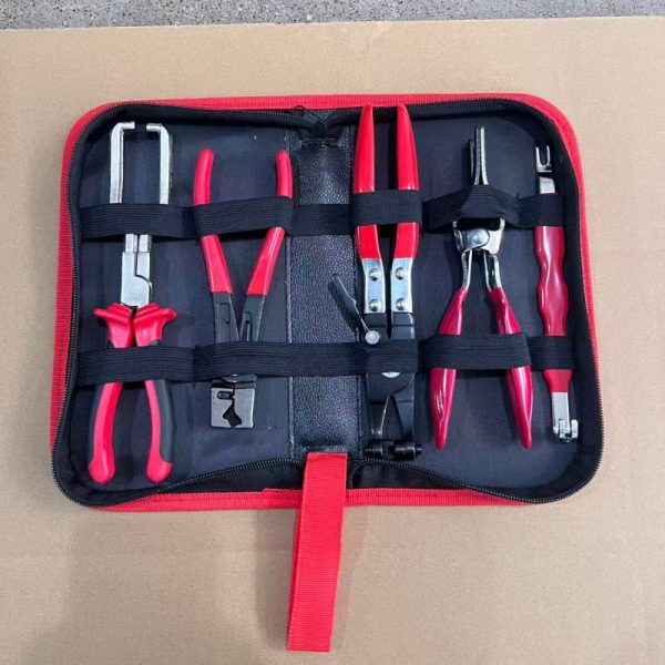 An overhead view of the 11-piece deluxe auto repair kit featuring pure red handle pliers, nylon trim removal tools, and electrical terminal extractors in a zippered case.