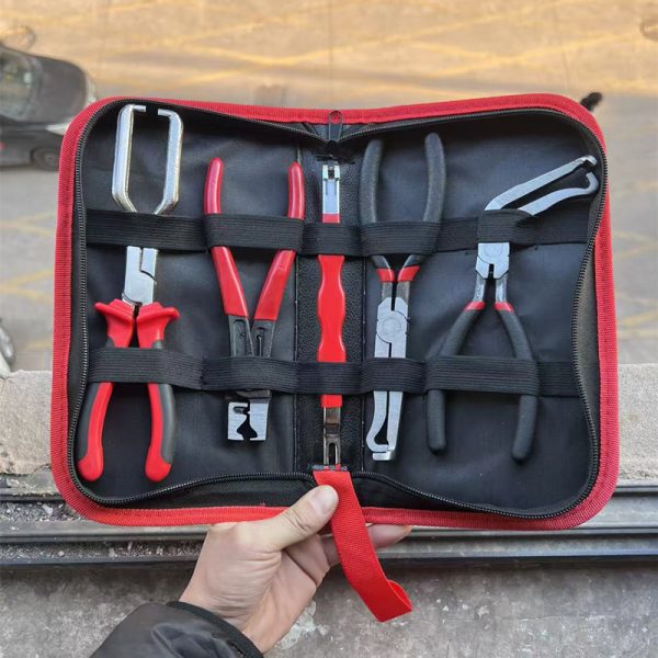 An overhead view of the 11-piece deluxe auto repair kit featuring pure red handle pliers, nylon trim removal tools, and electrical terminal extractors in a zippered case.