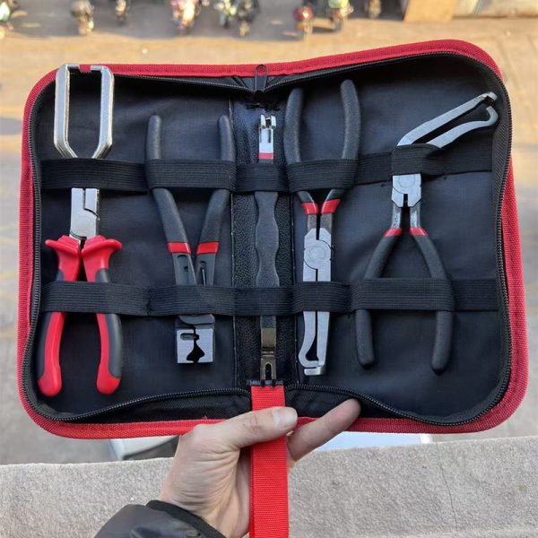 An overhead view of the 11-piece deluxe auto repair kit featuring pure red handle pliers, nylon trim removal tools, and electrical terminal extractors in a zippered case.