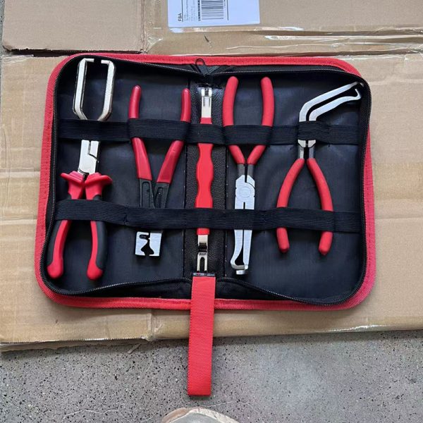 An overhead view of the 11-piece deluxe auto repair kit featuring pure red handle pliers, nylon trim removal tools, and electrical terminal extractors in a zippered case.