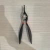 9-piece red and black automotive repair tool set featuring long nose pliers, hose clamp pliers, cutters, and a black anti-slip mechanic glove arranged on a white background.