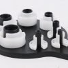 Seven piece white and black plastic fuel line disconnect tool set on a hanging board, sizes from 1/4 inch to 7/8 inch, used for removing car AC and fuel line quick connectors.
