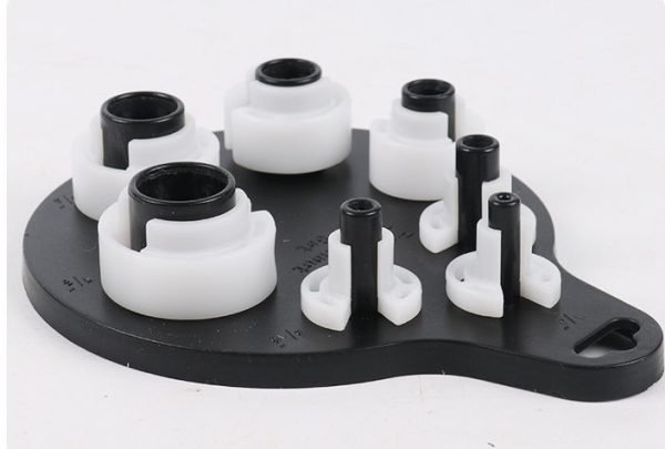 Seven piece white and black plastic fuel line disconnect tool set on a hanging board, sizes from 1/4 inch to 7/8 inch, used for removing car AC and fuel line quick connectors.