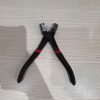 9-piece red and black automotive repair tool set featuring long nose pliers, hose clamp pliers, cutters, and a black anti-slip mechanic glove arranged on a white background.