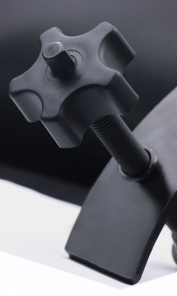 Full view of the black brake caliper press tool showing the ergonomic nylon knob and curved pressure plate.